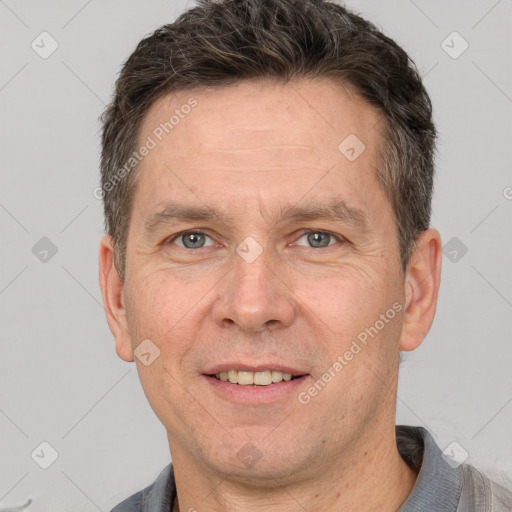 Joyful white adult male with short  brown hair and brown eyes