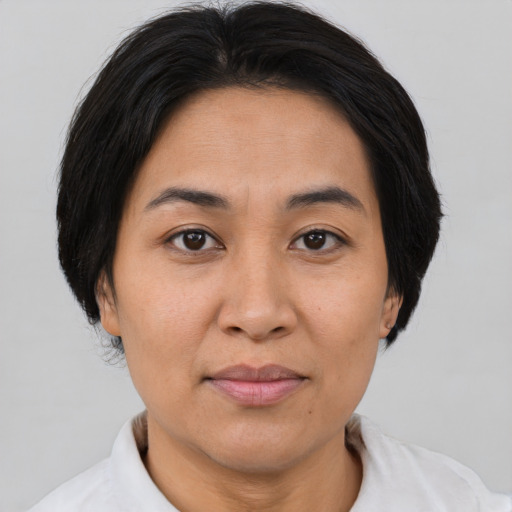 Joyful asian adult female with short  brown hair and brown eyes