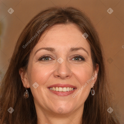 Joyful white adult female with long  brown hair and grey eyes