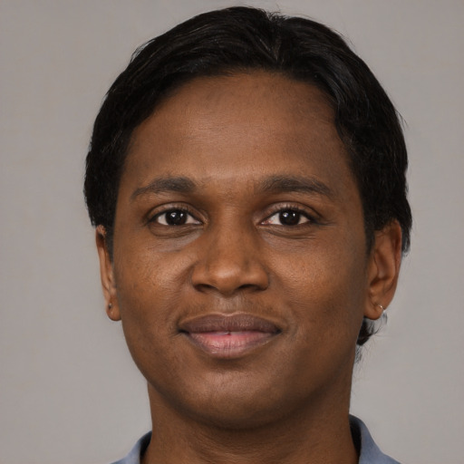 Joyful black young-adult male with short  black hair and brown eyes