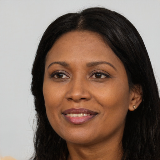 Joyful latino adult female with long  brown hair and brown eyes