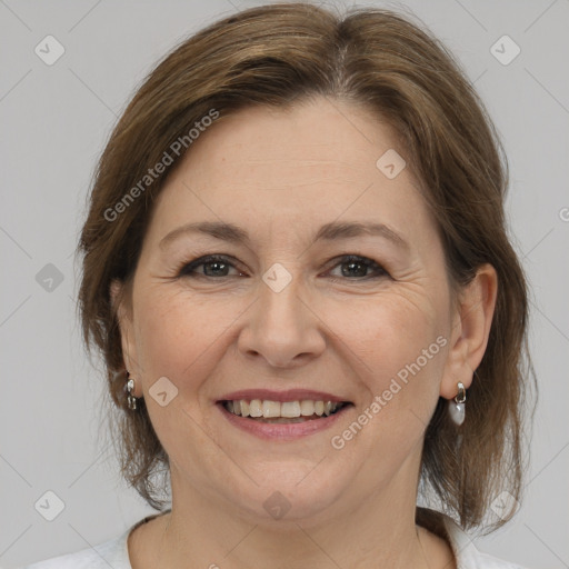 Joyful white adult female with medium  brown hair and brown eyes