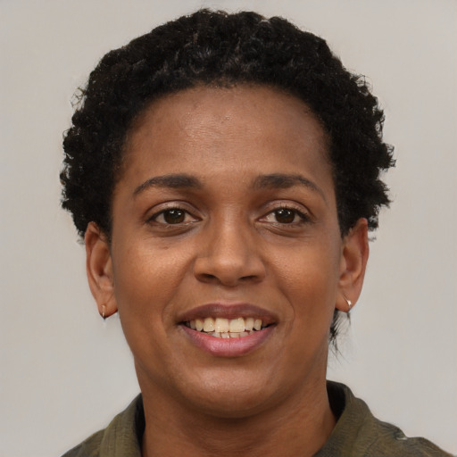 Joyful black young-adult female with short  brown hair and brown eyes