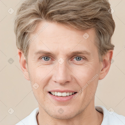 Joyful white adult male with short  brown hair and grey eyes