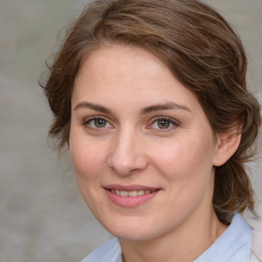 Joyful white young-adult female with medium  brown hair and blue eyes