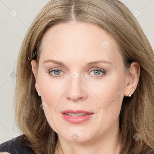 Joyful white adult female with long  brown hair and grey eyes