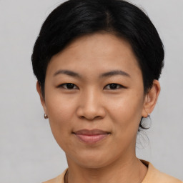 Joyful asian young-adult female with short  black hair and brown eyes