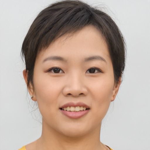 Joyful asian young-adult female with short  brown hair and brown eyes