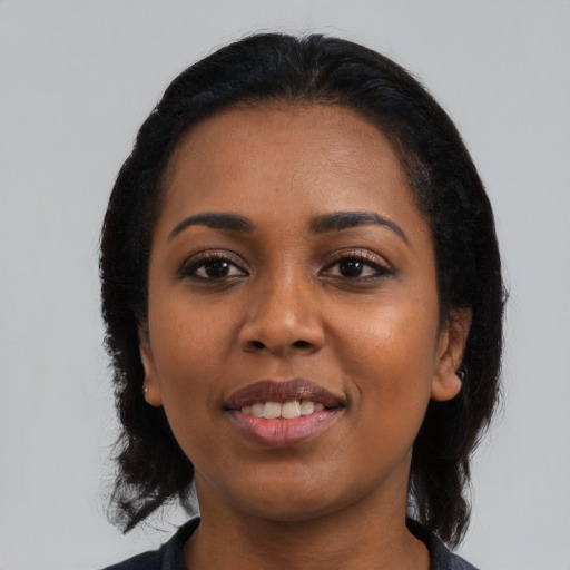 Joyful black young-adult female with medium  black hair and brown eyes