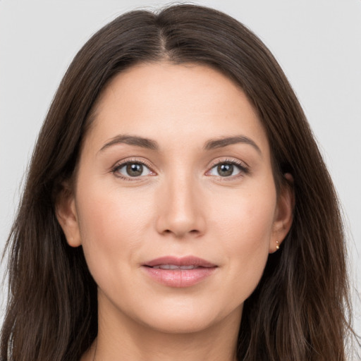 Joyful white young-adult female with long  brown hair and grey eyes