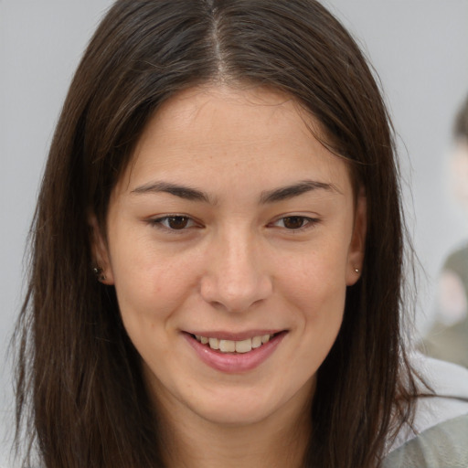 Joyful white young-adult female with long  brown hair and brown eyes