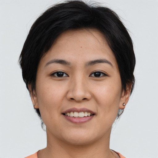 Joyful asian young-adult female with short  brown hair and brown eyes