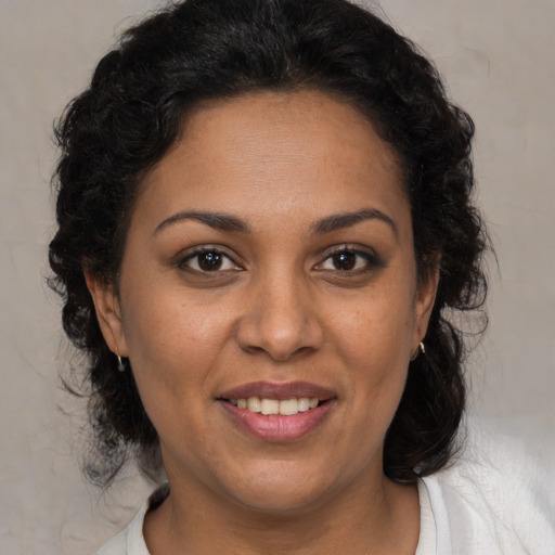 Joyful white adult female with medium  brown hair and brown eyes