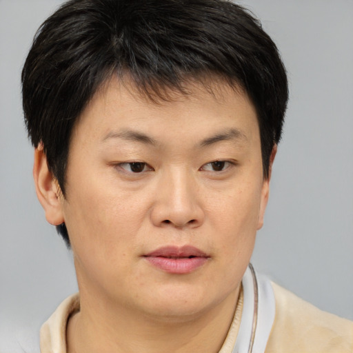 Joyful asian young-adult female with short  brown hair and brown eyes