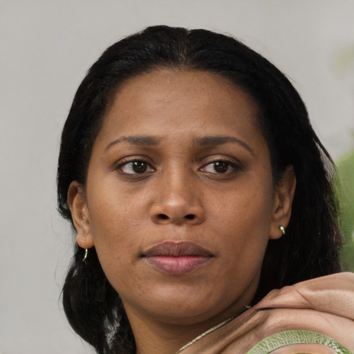 Joyful black young-adult female with medium  black hair and brown eyes