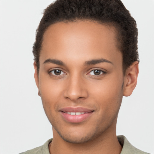 Joyful latino young-adult male with short  brown hair and brown eyes