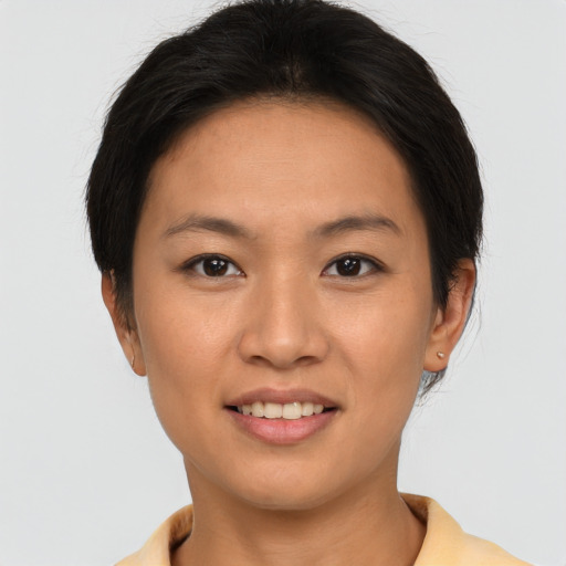 Joyful asian young-adult female with short  brown hair and brown eyes