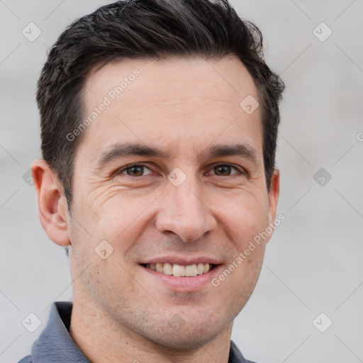 Joyful white adult male with short  brown hair and grey eyes