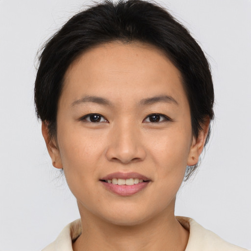 Joyful asian young-adult female with medium  brown hair and brown eyes