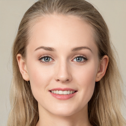 Joyful white young-adult female with long  brown hair and blue eyes