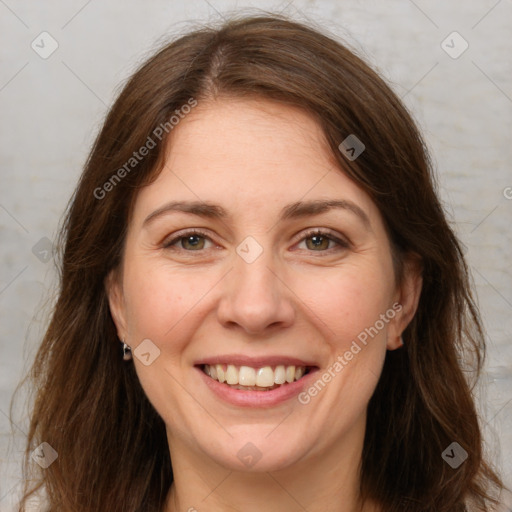 Joyful white adult female with long  brown hair and green eyes