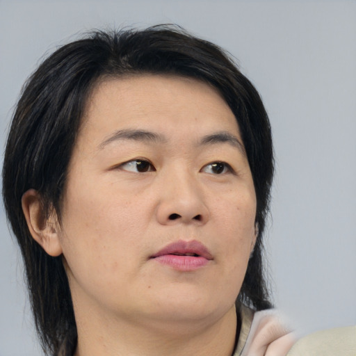Neutral asian young-adult female with medium  brown hair and brown eyes