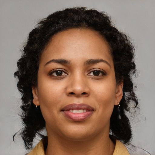 Joyful black young-adult female with medium  brown hair and brown eyes