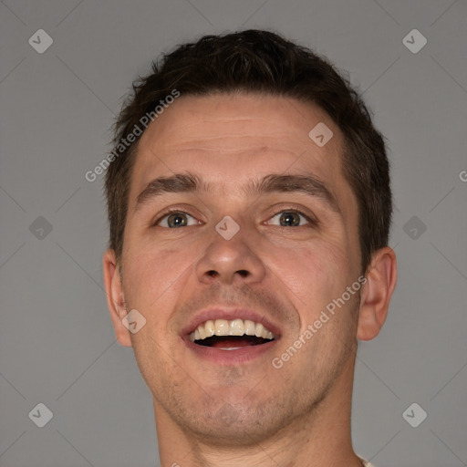 Joyful white adult male with short  brown hair and brown eyes