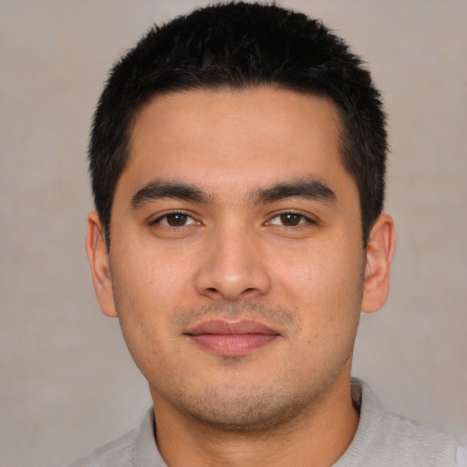 Joyful asian young-adult male with short  black hair and brown eyes