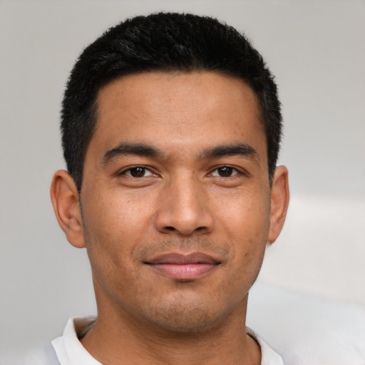 Joyful asian young-adult male with short  black hair and brown eyes