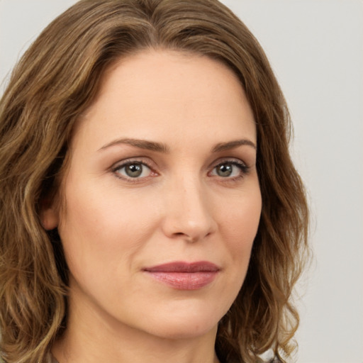 Joyful white young-adult female with long  brown hair and green eyes