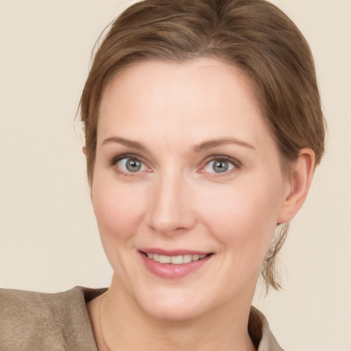 Joyful white young-adult female with medium  brown hair and grey eyes