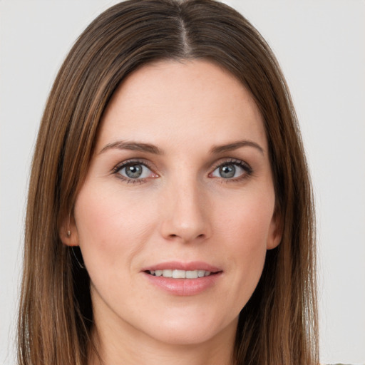 Joyful white young-adult female with long  brown hair and grey eyes