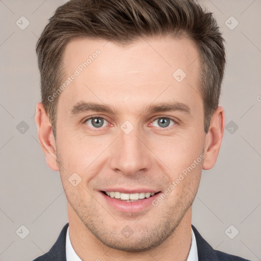 Joyful white young-adult male with short  brown hair and grey eyes