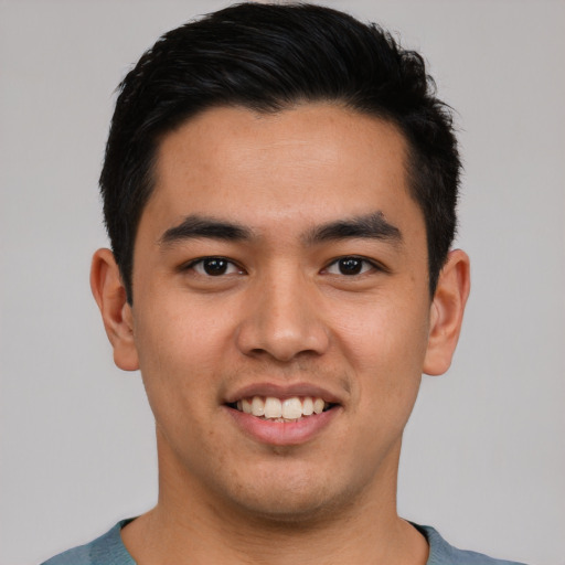 Joyful asian young-adult male with short  brown hair and brown eyes