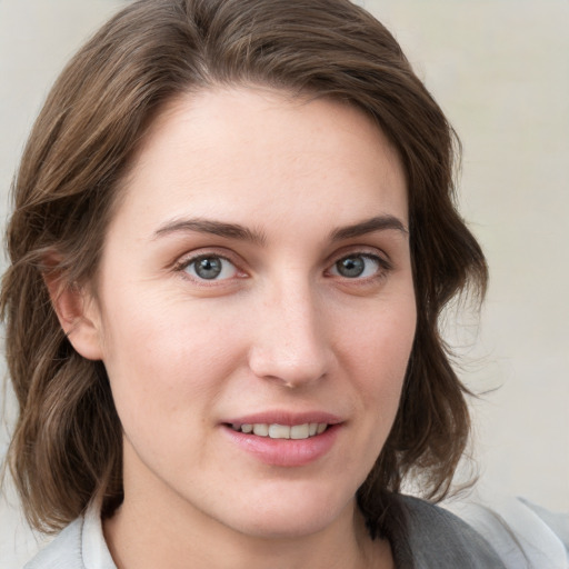 Joyful white young-adult female with medium  brown hair and blue eyes