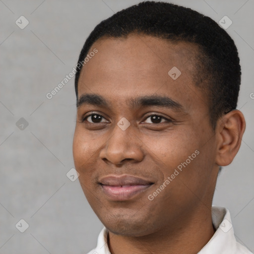 Joyful black young-adult male with short  black hair and brown eyes