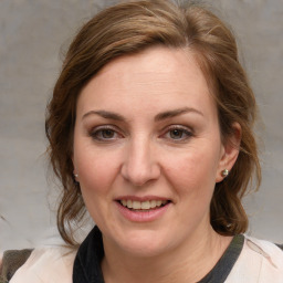 Joyful white young-adult female with medium  brown hair and blue eyes