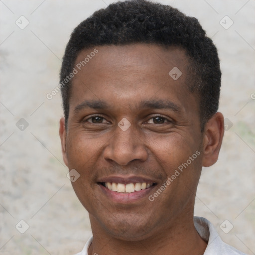 Joyful black young-adult male with short  black hair and brown eyes