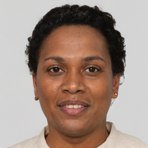 Joyful black adult female with short  black hair and brown eyes