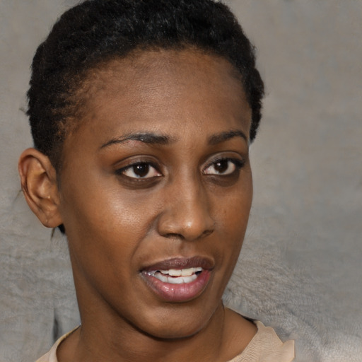 Joyful black young-adult female with short  brown hair and brown eyes