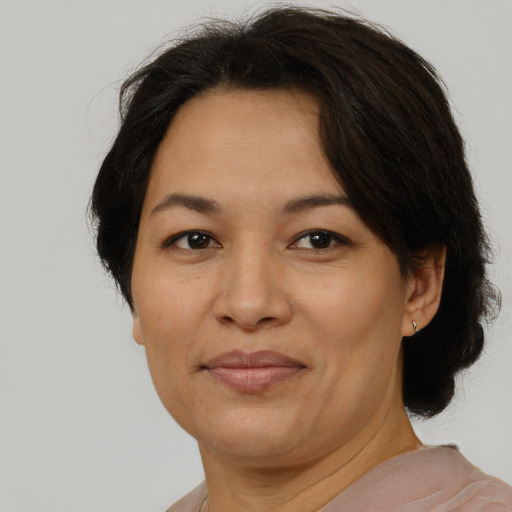 Joyful asian adult female with short  brown hair and brown eyes
