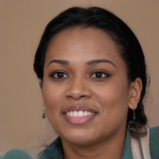 Joyful black young-adult female with medium  brown hair and brown eyes