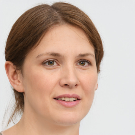 Joyful white young-adult female with medium  brown hair and green eyes