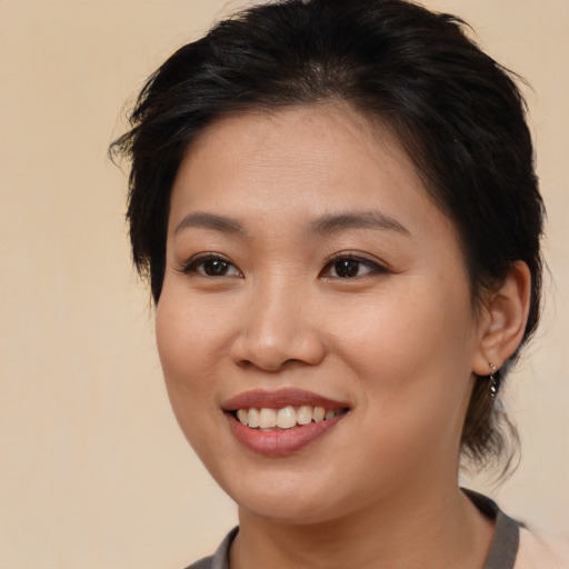 Joyful white young-adult female with medium  brown hair and brown eyes