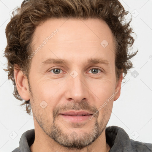 Joyful white adult male with short  brown hair and grey eyes