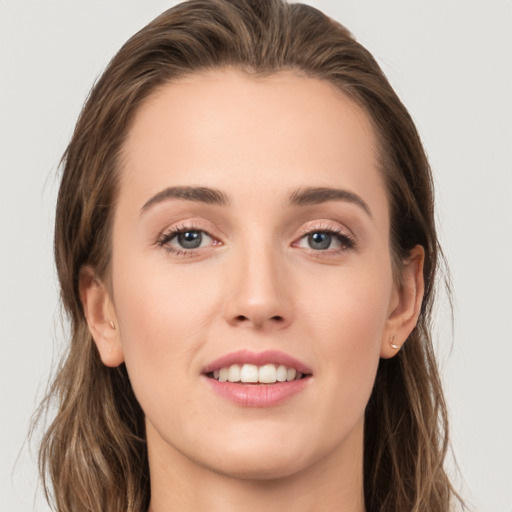 Joyful white young-adult female with long  brown hair and grey eyes