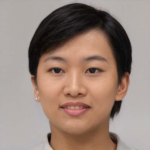 Joyful asian young-adult female with medium  black hair and brown eyes