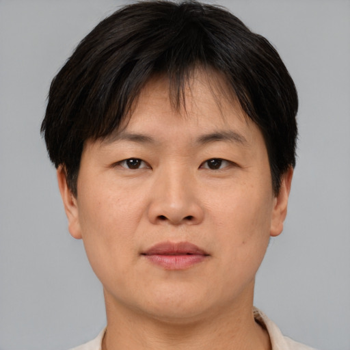 Neutral asian adult male with short  brown hair and brown eyes