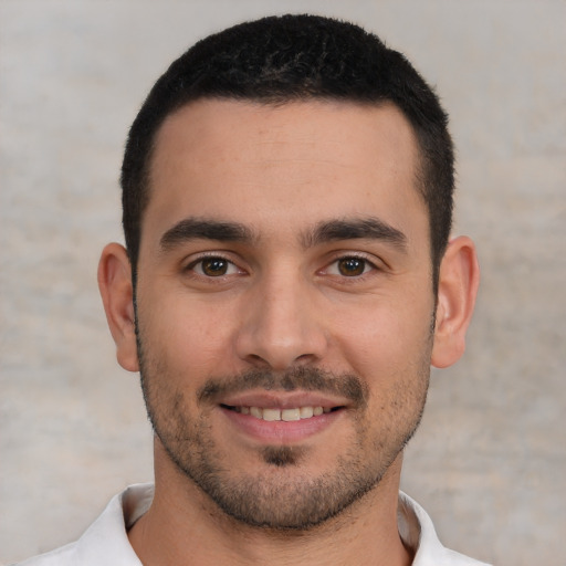 Joyful white young-adult male with short  black hair and brown eyes